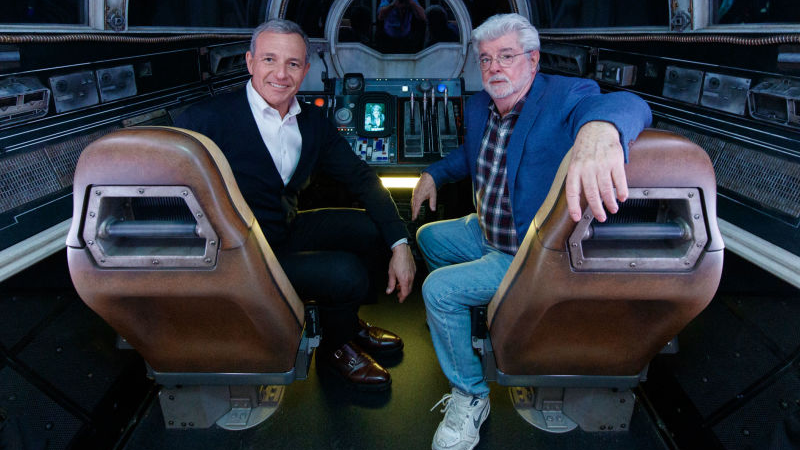 Disney CEO Bob Iger and George Lucas—the man who gave Disney what is now one of its most important moneymakers—sitting in the cockpit of the Millennium Falcon: Smugglers Run ride at the heart of Disneyland’s Star Wars-themed park, Galaxy’s Edge.